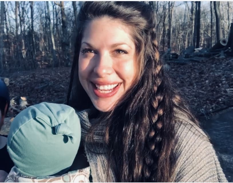 Raeanna standing in the forest